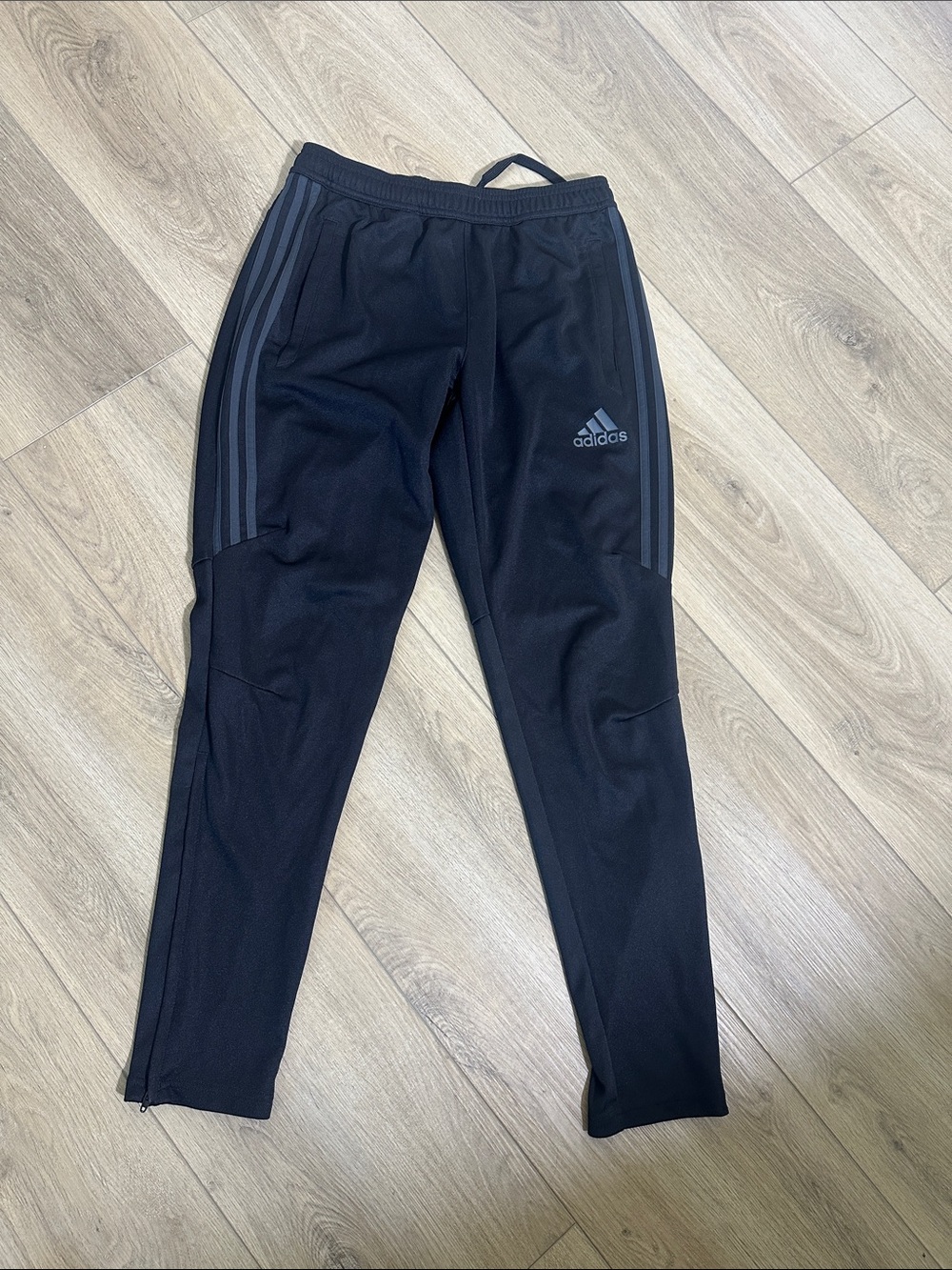 Womens Adidas Black Joggers with Gray stripes zippers on outsides of legs. Med